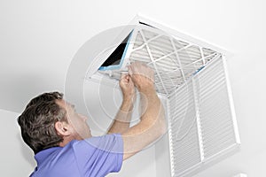 Man Removing Dirty Air Filter photo