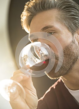 Mature Man Tasting Red Wine