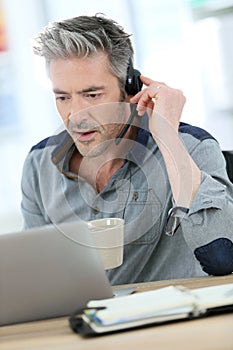 Mature man teleworking from home photo