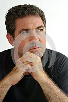 Mature man thinking with hands on chin