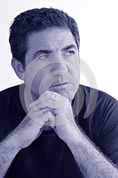 Mature man thinking with hands on chin