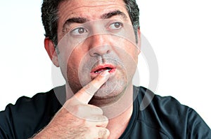 Mature man thinking with one finger on his lips