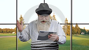 Mature man using app on digital tablet.