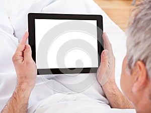 Mature man using digital tablet