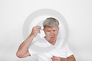 man using hearing aids to compensate hearing loss photo