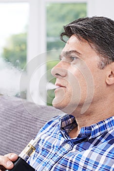 Mature Man Using Vapourizer As Smoking Alternative