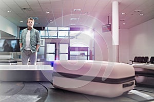 Mature man waiting for his suit case on baggage claiming area in airport