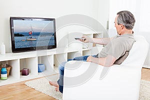 Mature man watching tv