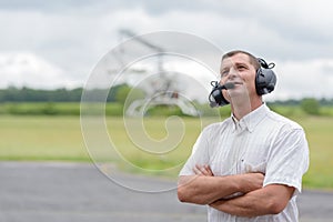 mature man wearing headset at airfeild