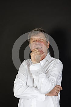 Mature man in white business shirt looking snotty