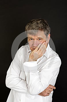 Mature man in white business shirt looking snotty