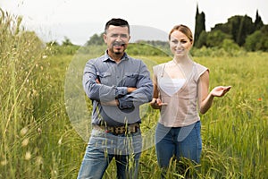 Mature man and woman standing in wheat field