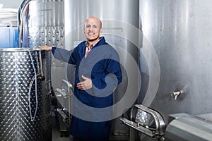 Mature man working in wine fermentation section