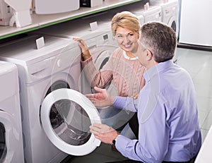 Mature married couple in shop of household appliances