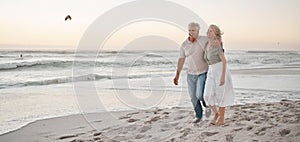 Mature married couple walking on the beach. Senior man hugging his wife by the ocean. Mature couple strolling on the