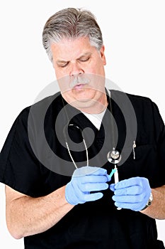 Mature medical doctor preparing syringe