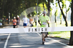 Mature man running towards the finish line photo