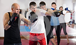 Mature men sparring in the boxing hall