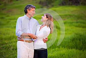 Mature middle age couple in love hugging photo