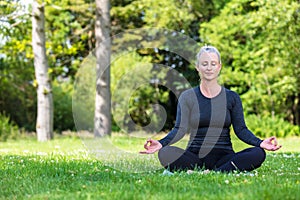 Mature Middle Aged Fit Healthy Woman Practicing Yoga Outside