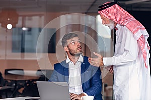 Mature Middle Eastern businessman wearing ghoutra in meeting photo