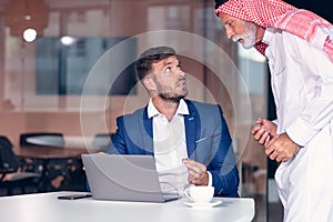 Mature Middle Eastern businessman wearing ghoutra in meeting photo