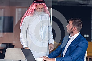 Mature Middle Eastern businessman wearing ghoutra in meeting photo