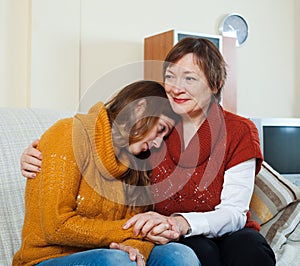 Mature mother gives solace to crying adult daughter