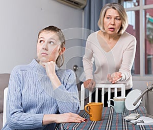 Mature mother scolds adult daughter