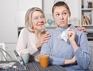 Mature mother soothes adult daughter