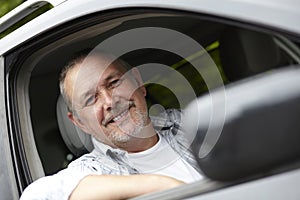 Mature Motorist Looking Out Of Car Window