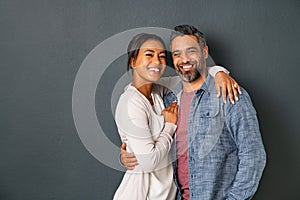 Mature multiethnic couple embracing and smiling together