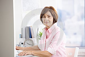 Mature office worker sitting at desk