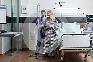 Mature old sick woman getting intravenous medicine