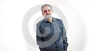 Mature older caucasian gray-haired bearded man pulling funny and silly faces in studio. White background copy space.