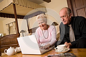 Mature older couple using laptop