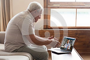 Mature older man holding video call with son.