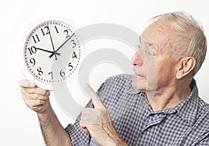 Mature older man looking at clock.