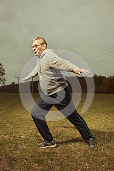 Mature older ugly man in glasses trying to be fitness icon