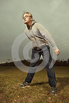 Mature older ugly man in glasses trying to be fitness icon