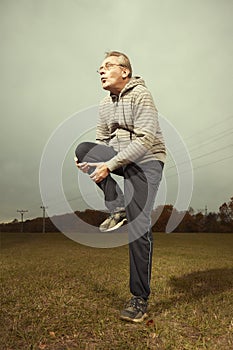 Mature older ugly man in glasses trying to be fitness icon