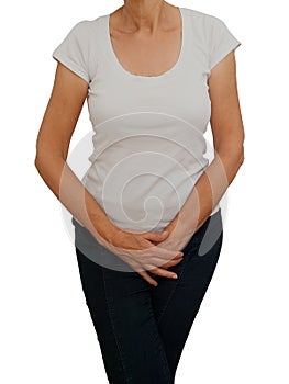 Mature, older woman holding crotch. Discomfort from incontinence, menopause or similar personal problem. White background