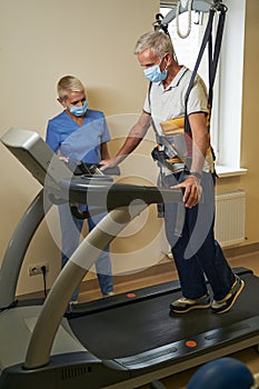 Mature patient doing exercises during rehabilitation in medical center