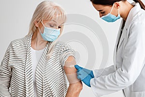 Mature Patient Getting Vaccinated Against Covid-19, Doctor Applying Plaster