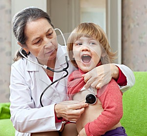 Mature pediatrician doctor examining baby