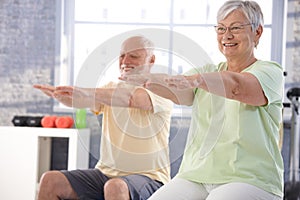 Mature people exercising happily