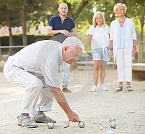 Mature people playing bocce