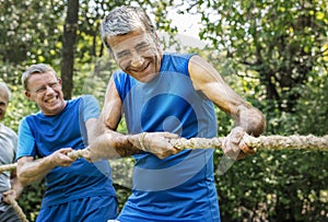 Mature people in tug of war