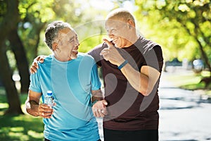 Mature, people and walk for wellness in closeup while talking, smile and bond. Elderly, men or friends for fitness