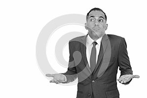 Mature Persian businessman shrugging shoulders in black and white